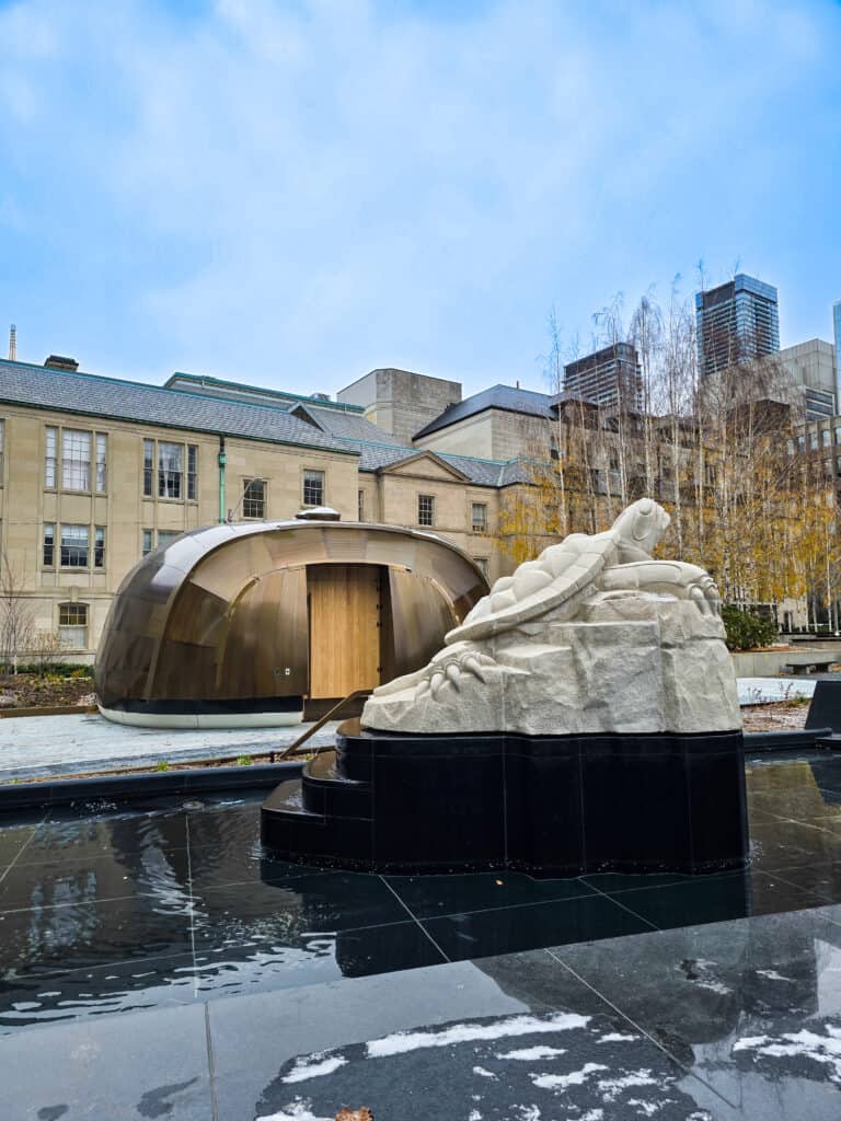 A turtle sculpture and first nations lodge at Nathan Phillips Square.