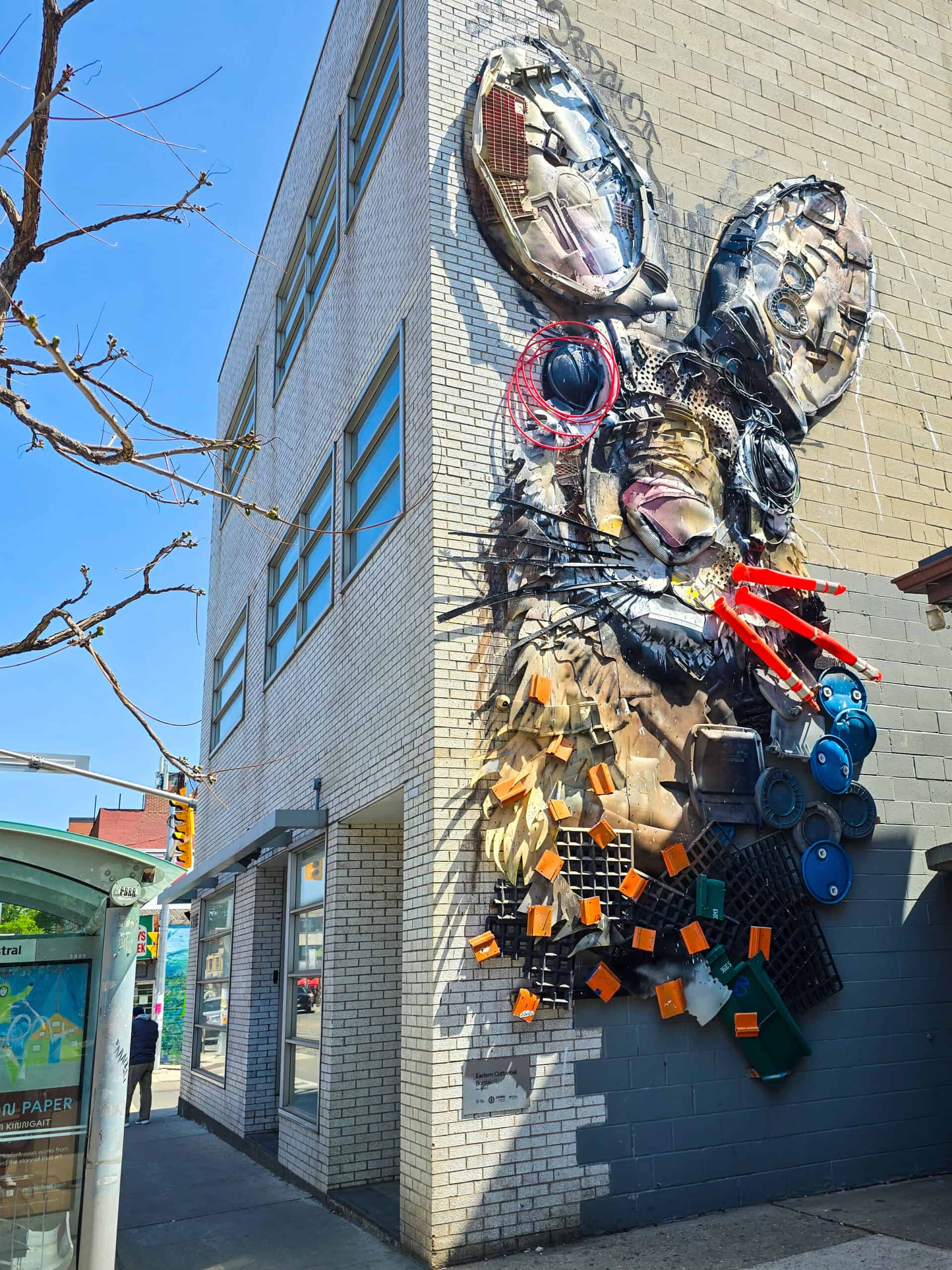 A large wall-mounted Bordalo II sculpture of a rabbit in Toronto's Little Portugal.